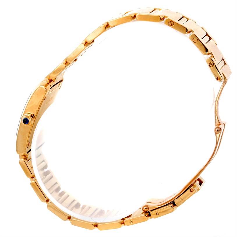 The image shows a side profile of the Cartier Tank Française watch, highlighting its gold bracelet and case.