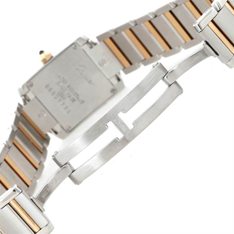 The image shows the underside of a Cartier Tank Française watch, highlighting the bracelet and clasp mechanism.