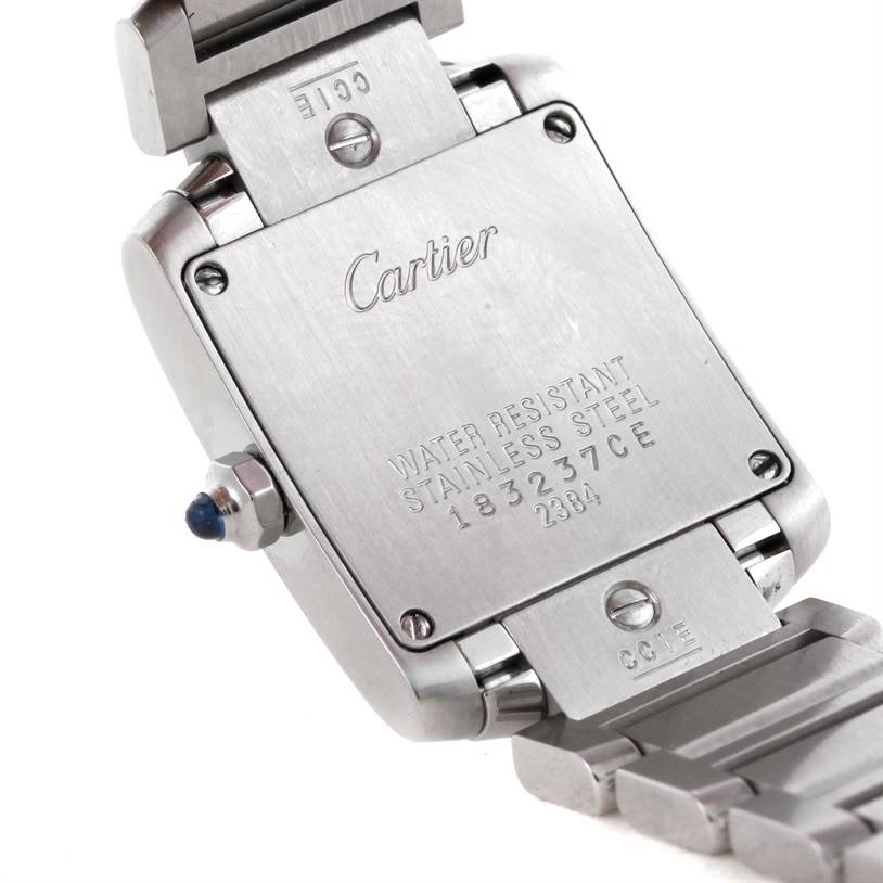 This image shows the back case and part of the stainless steel bracelet of a Cartier Tank Française watch.