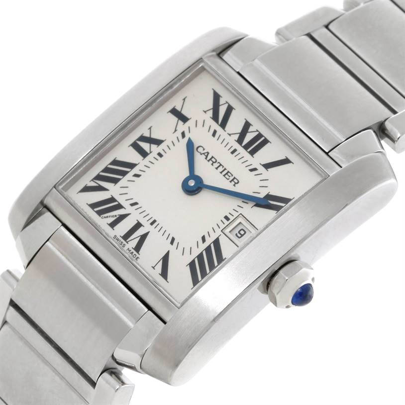 The image shows a close-up of the Cartier Tank Française watch, highlighting its face, crown, and part of the bracelet.
