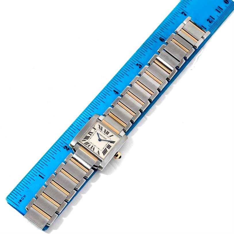 This image shows the Cartier Tank Francaise W51012Q4 Women's Steel and Gold (two tone) Silver Dial W51012Q4 Women's Steel and Gold (two tone) Silver Dial watch flat, face-up, alongside a ruler for scale.