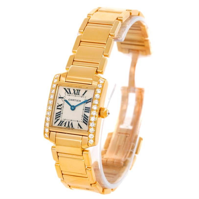 The image shows a Tank Francaise by Cartier at a slightly diagonal front angle, displaying its rectangular face, roman numerals, and gold bracelet.