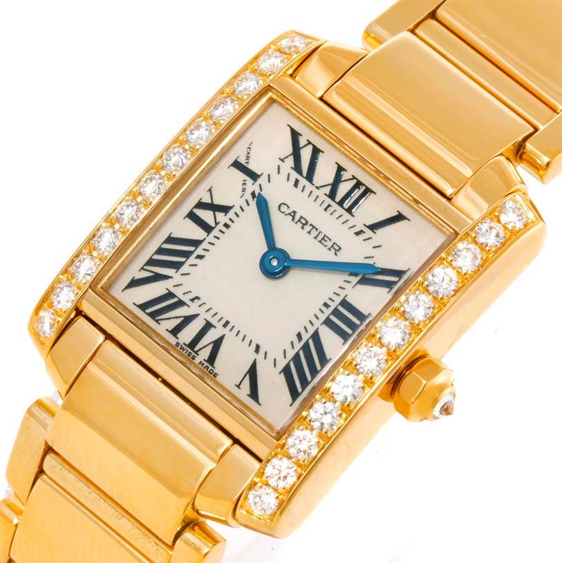 The image shows a close-up angle of the Cartier Tank Francaise WE1001R8 Women's Yellow Gold Silver Dial WE1001R8 Women's Yellow Gold Silver Dial watch, highlighting its dial, Roman numerals, and diamond-encrusted bezel.