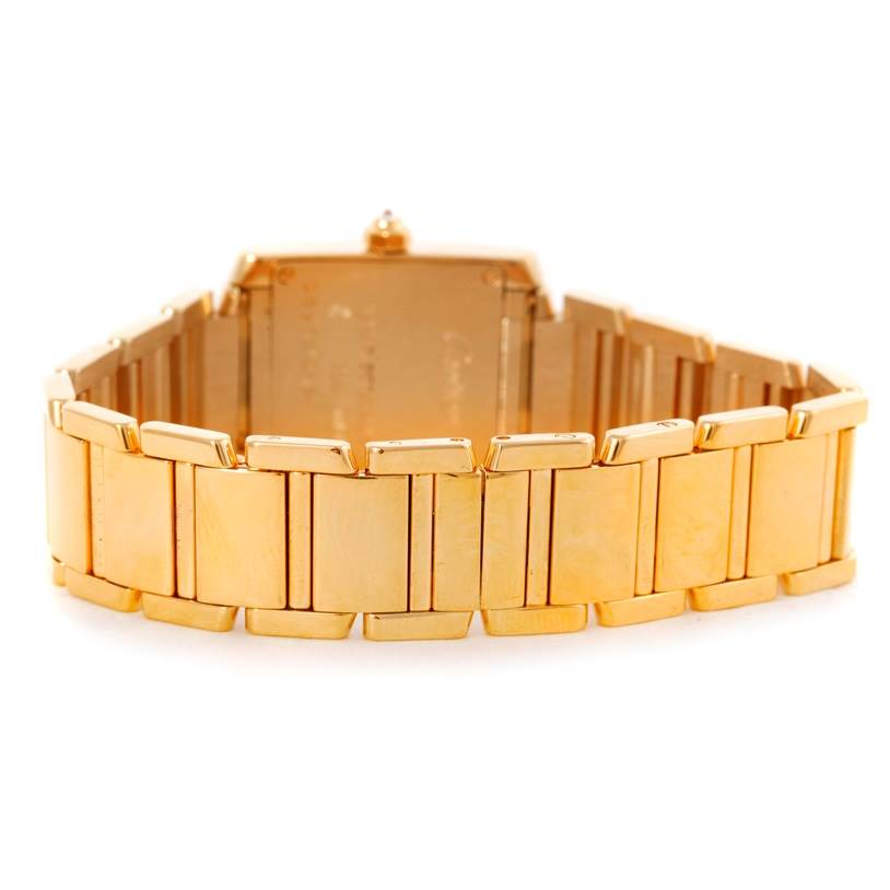 This image shows the gold bracelet and clasp of the Tank Française watch by Cartier from a rear angle.