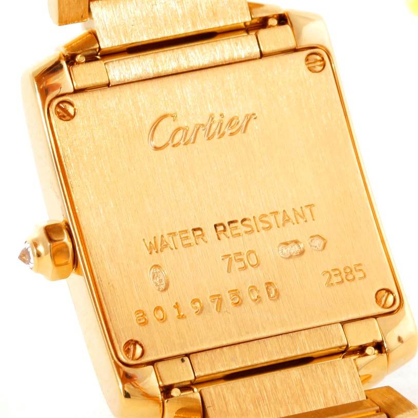 The image shows the back view of a Tank Française model by Cartier, highlighting its water resistance details and serial numbers.