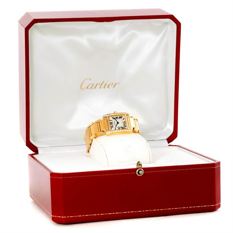 The Cartier Tank Francaise WE1001R8 Women's Yellow Gold Silver Dial WE1001R8 Women's Yellow Gold Silver Dial watch is displayed in its open red and white Cartier box, showing the front and bracelet.