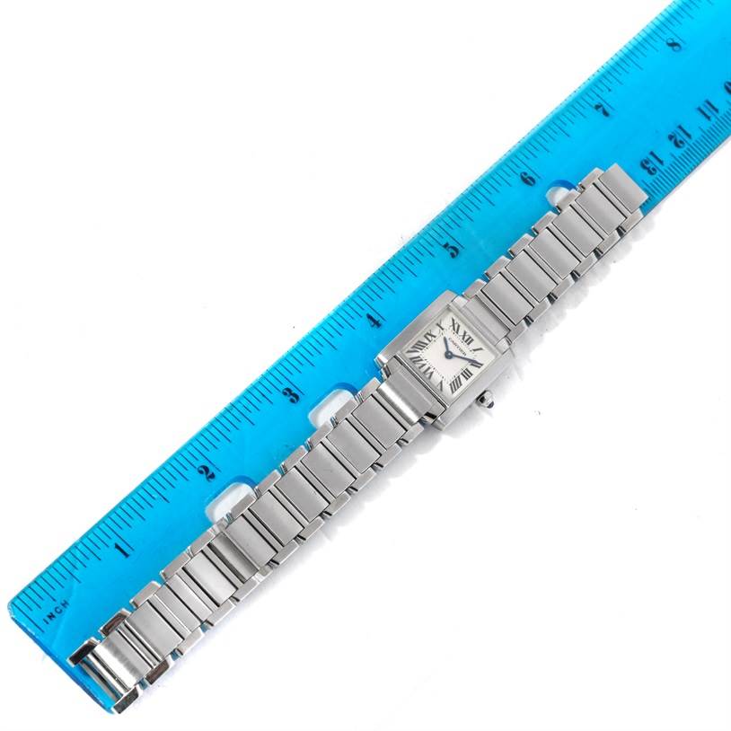 The image shows a Cartier Tank Francaise W51008Q3 Women's Stainless Steel Silver Dial W51008Q3 Women's Stainless Steel Silver Dial watch laid flat next to a blue ruler, displaying its entire bracelet and rectangular case.