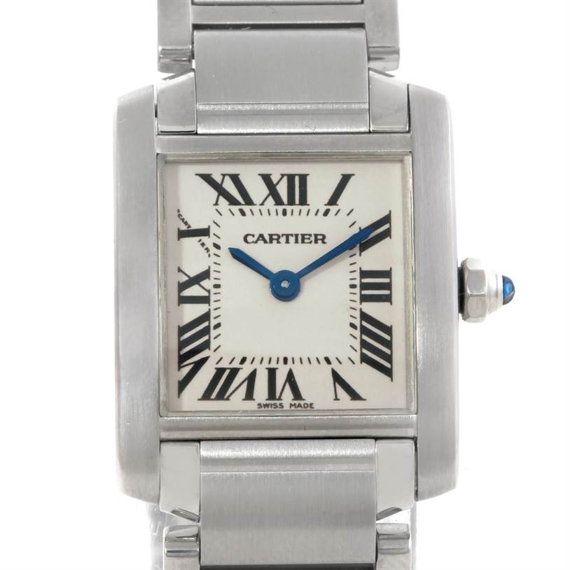 The image shows a Tank Française watch by Cartier, focusing on the square face and part of the metal band, with clear visibility of the Roman numerals and blue hands.