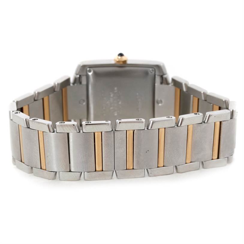 The image shows the back view of a Cartier Tank Française watch, focusing on its two-tone metal bracelet and case rear.