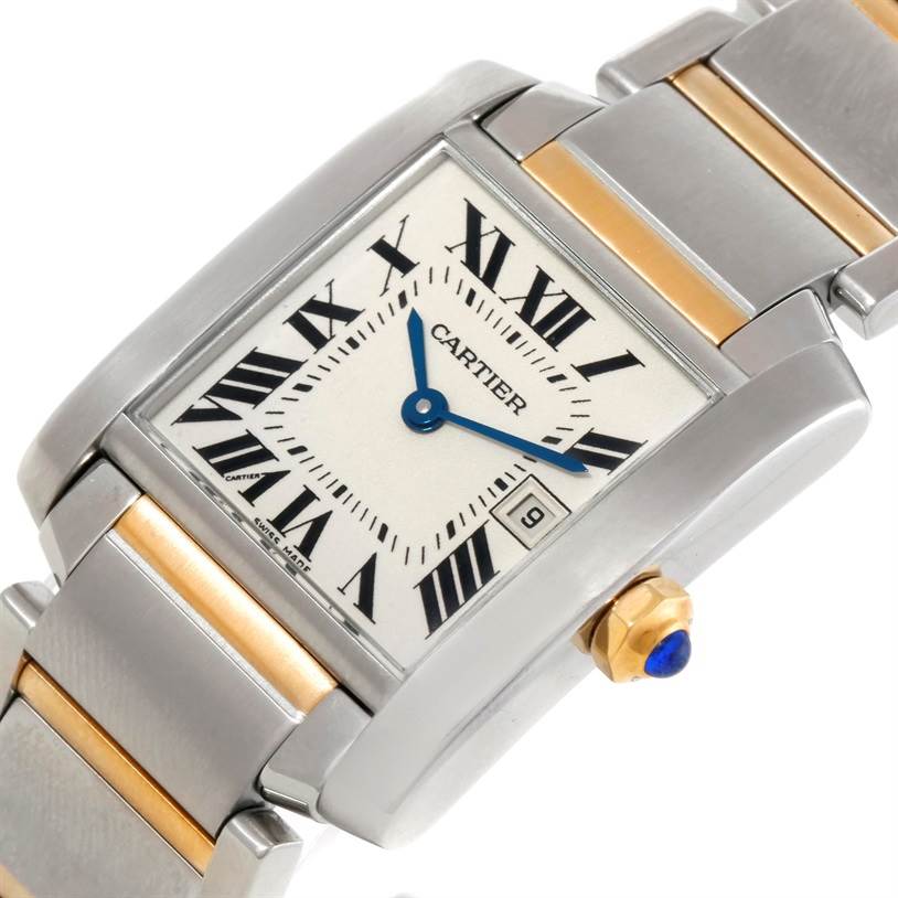 The image shows a close-up of a Cartier Tank Francaise W51012Q4 Women's Steel and Gold (two tone) Silver Dial W51012Q4 Women's Steel and Gold (two tone) Silver Dial watch, highlighting its square face, metal bracelet, and blue cabochon crown.