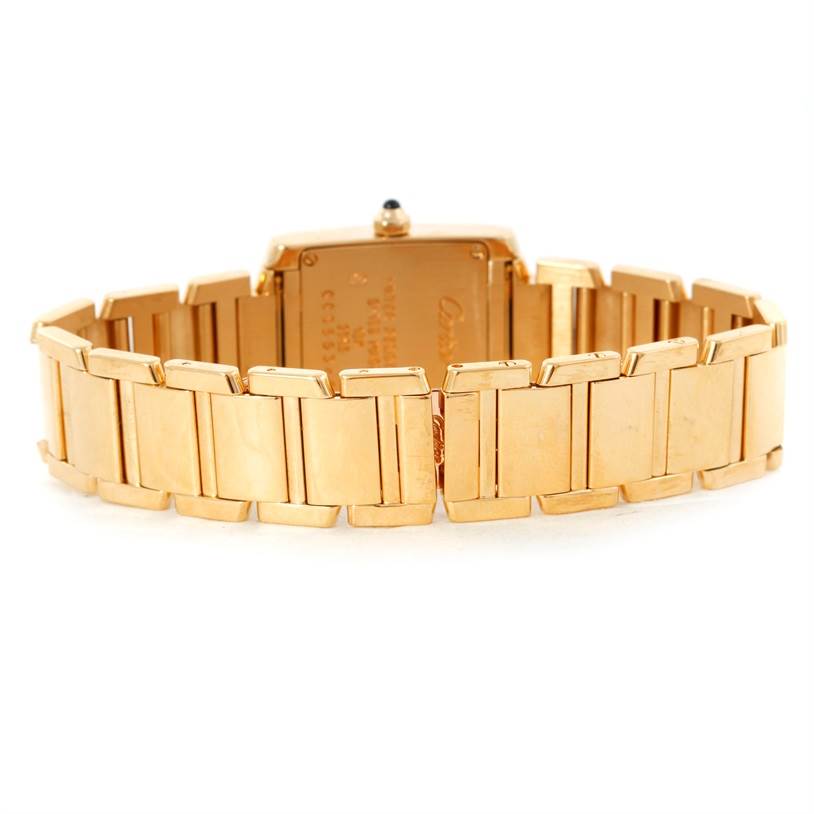 This image shows the back view of the gold bracelet and case back of a Cartier Tank Française watch.