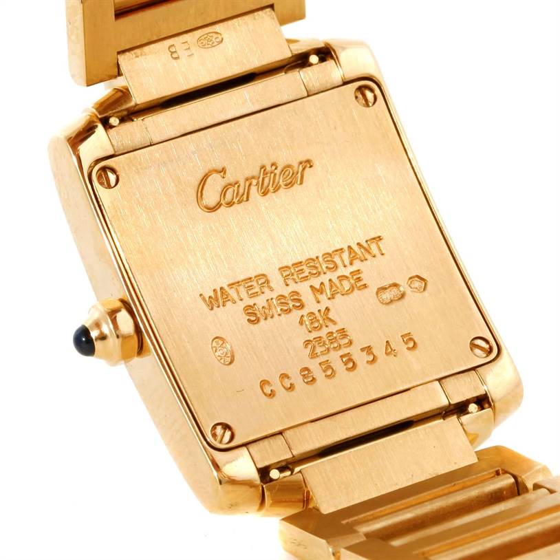 The image shows the back of a gold Cartier Tank Francaise W50002N2 Women's Yellow Gold Silver Dial W50002N2 Women's Yellow Gold Silver Dial watch, highlighting its water-resistant and Swiss-made engravings.