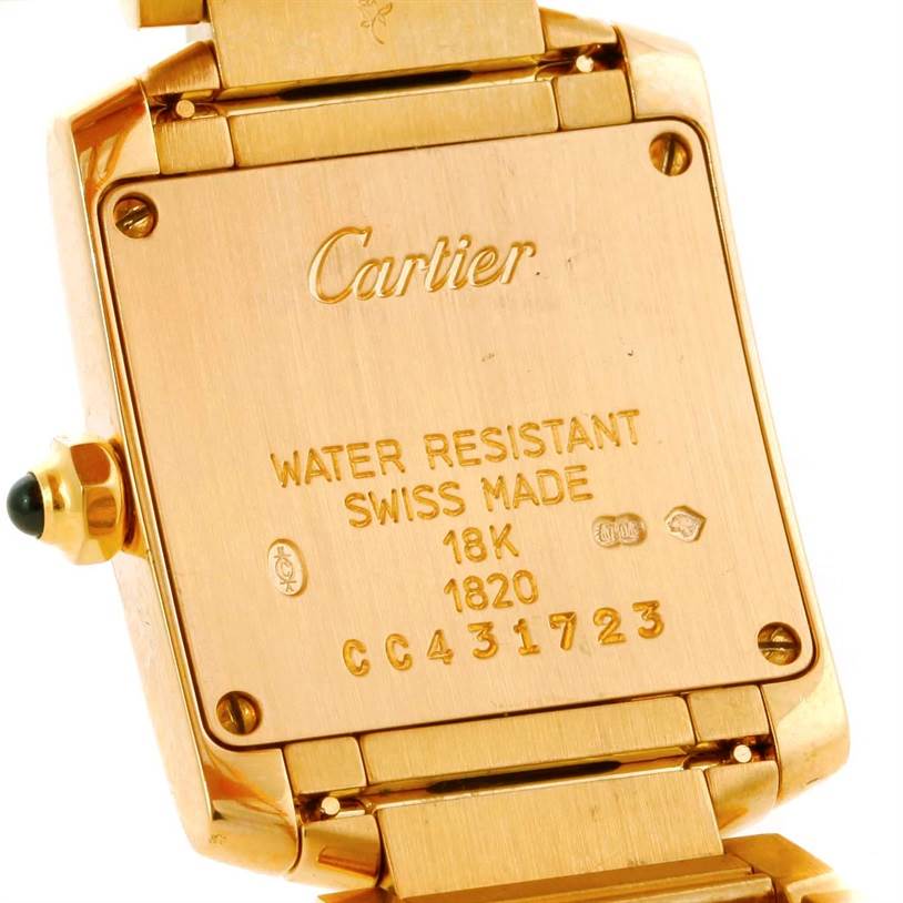 This image shows the back of a Cartier Tank Française watch, highlighting its markings and case details.