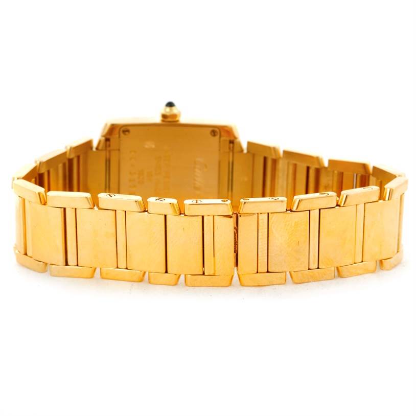 This Cartier Tank Francaise W50002N2 Women's Yellow Gold Silver Dial W50002N2 Women's Yellow Gold Silver Dial watch is shown from the back, highlighting its gold bracelet and case.