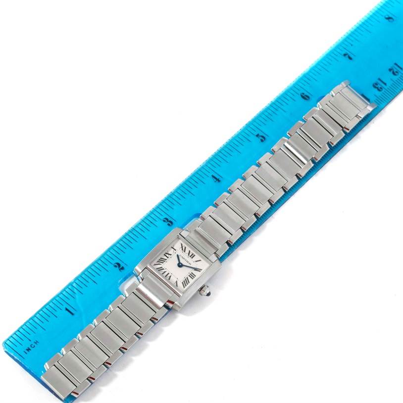 The Cartier Tank Francaise W51008Q3 Women's Stainless Steel Silver Dial W51008Q3 Women's Stainless Steel Silver Dial watch is shown from a top-down angle, fully extended with a ruler for scale.