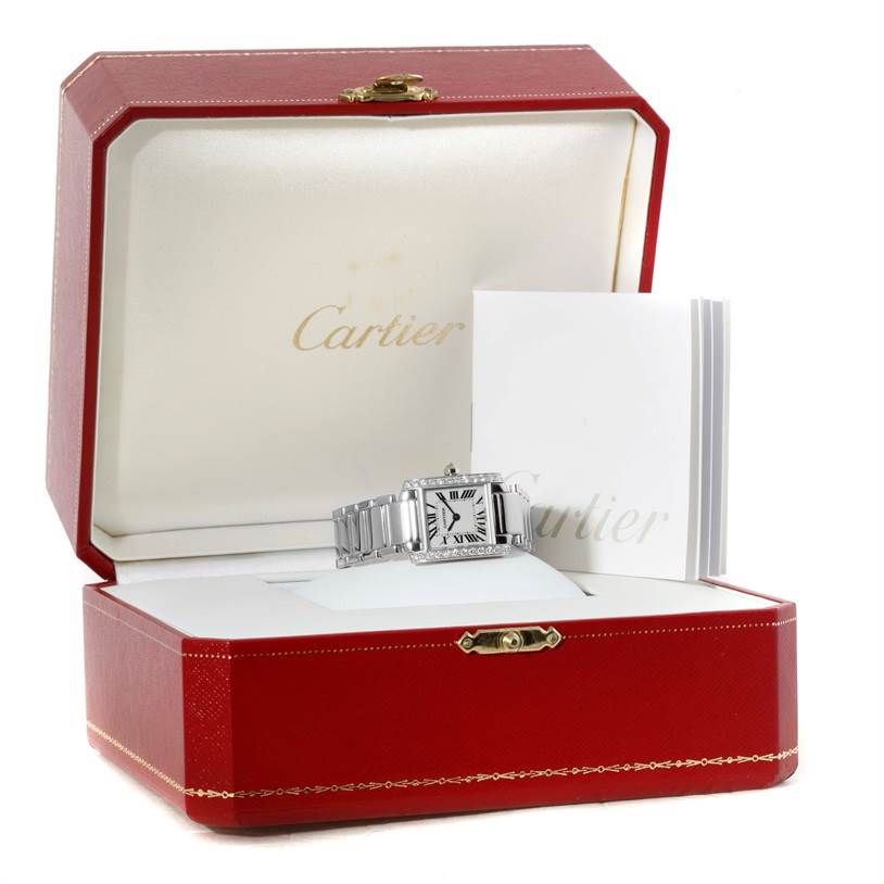 The Cartier Tank Francaise WE1002S3 Women's White Gold Silver Dial WE1002S3 Women's White Gold Silver Dial watch is displayed in an open red box, showing the face and bracelet alongside documentation.