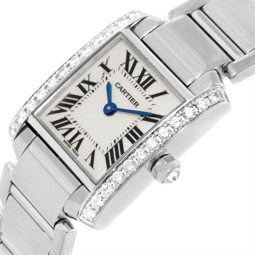The image shows a close-up of a Cartier Tank Francaise WE1002S3 Women's White Gold Silver Dial WE1002S3 Women's White Gold Silver Dial watch face with diamond accents and part of the metal bracelet.