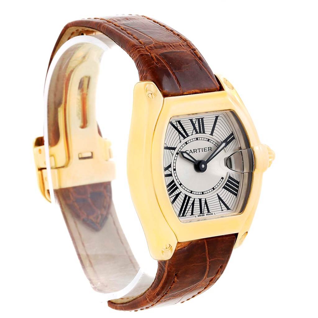 The image shows a Cartier Roadster W62018Y5 Women's Yellow Gold Silver Dial W62018Y5 Women's Yellow Gold Silver Dial watch at a slight side angle, highlighting its face, leather band, and gold casing.