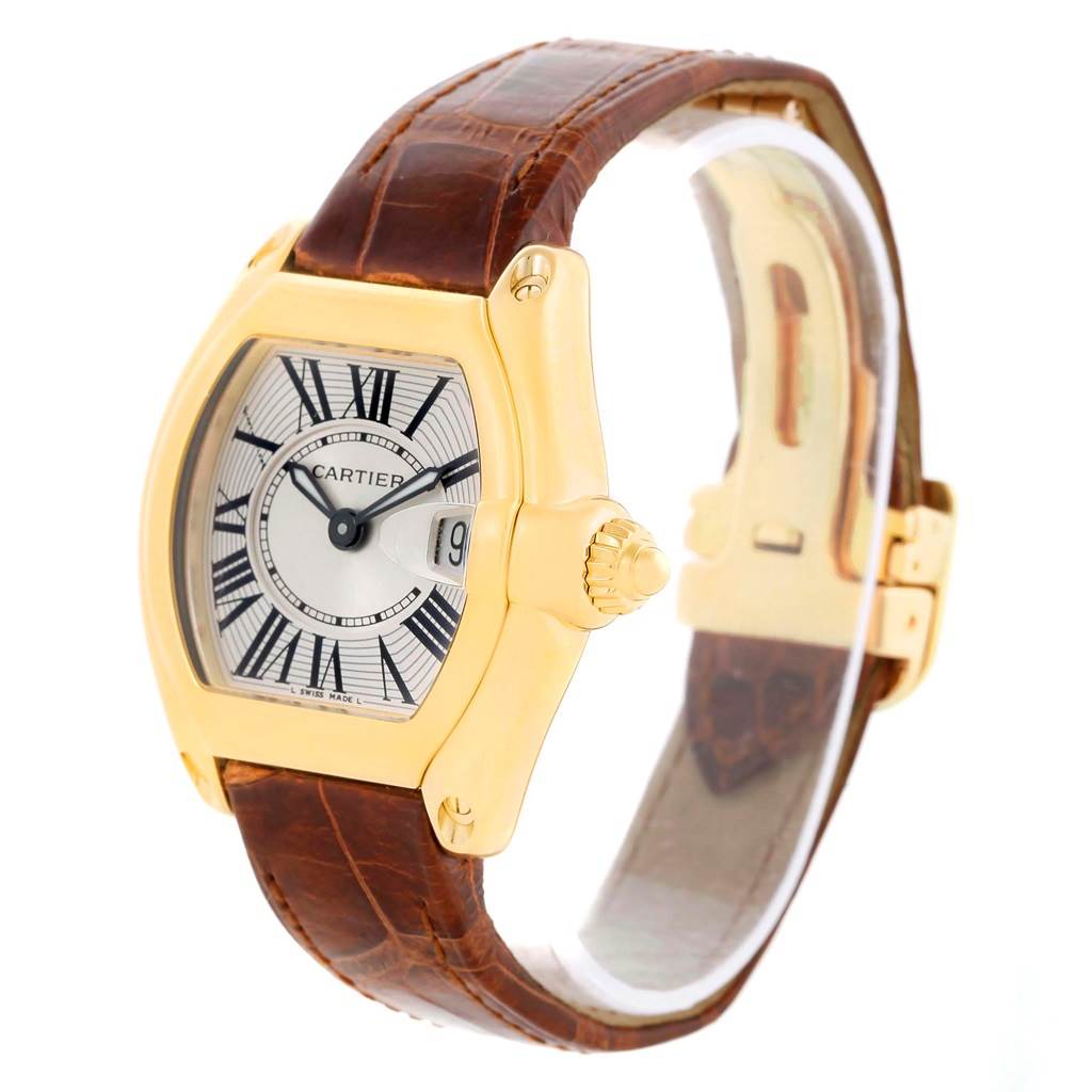 The Cartier Roadster W62018Y5 Women's Yellow Gold Silver Dial W62018Y5 Women's Yellow Gold Silver Dial watch is shown at a slight angle, highlighting its dial, crown, and leather strap.