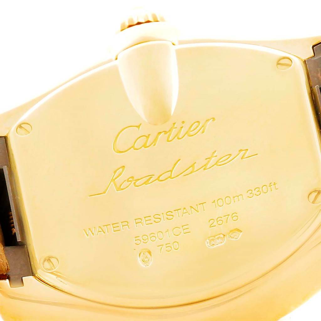 This image shows a close-up of the back case of a Cartier Roadster W62018Y5 Women's Yellow Gold Silver Dial W62018Y5 Women's Yellow Gold Silver Dial watch, displaying its engravings and the crown.