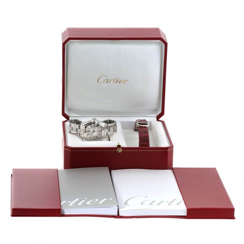 This image shows the Cartier Roadster W62016V3 Women's Stainless Steel Silver Dial W62016V3 Women's Stainless Steel Silver Dial watch and accessories, including a metal bracelet, an additional strap, and packaging.