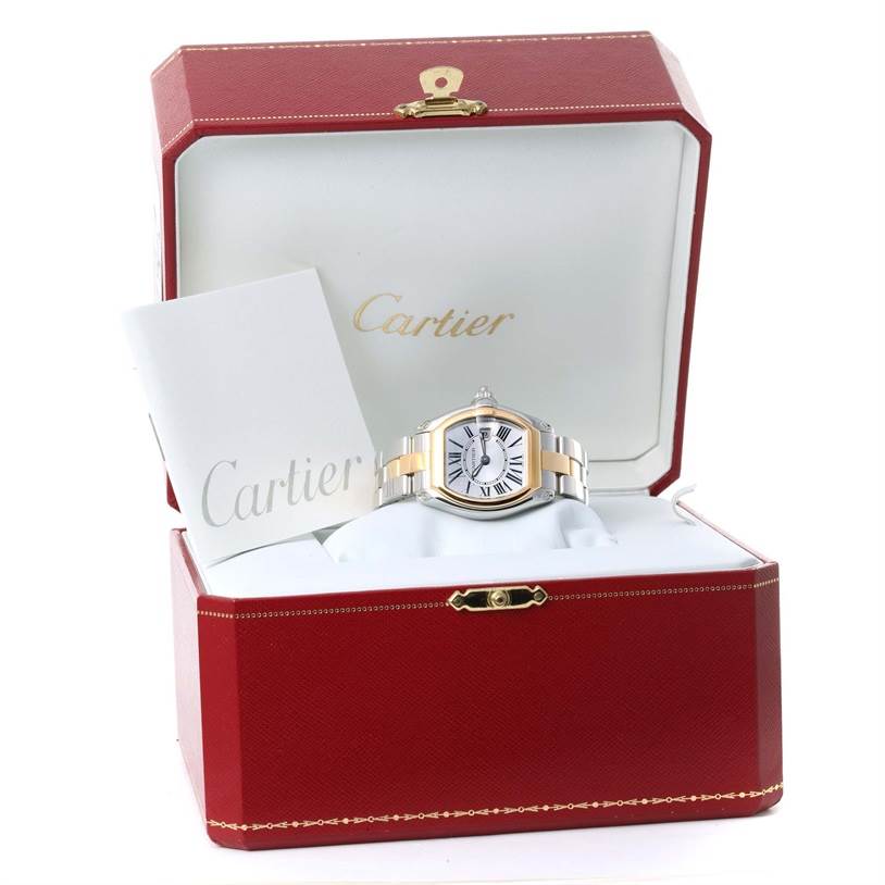 The Cartier Roadster W62026Y4 Women's Steel and Gold (two tone) Silver Dial W62026Y4 Women's Steel and Gold (two tone) Silver Dial watch is displayed front-facing inside an open red Cartier box with a booklet on the left.