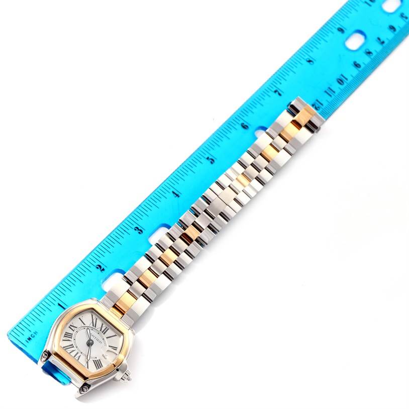 The Cartier Roadster W62026Y4 Women's Steel and Gold (two tone) Silver Dial W62026Y4 Women's Steel and Gold (two tone) Silver Dial watch is shown from a top-down angle, featuring the face and the entire strap next to a ruler for scale.