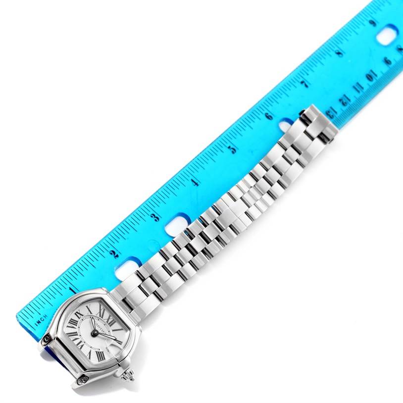 The Cartier Roadster W62016V3 Women's Stainless Steel Silver Dial W62016V3 Women's Stainless Steel Silver Dial watch is displayed face-up alongside a blue ruler for size comparison, showing the case and bracelet.