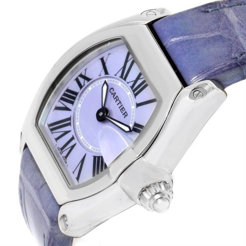 The image shows a close-up, side angle of the Cartier Roadster W6206007 Stainless Steel Mother of Pearl Dial W6206007 Stainless Steel Mother of Pearl Dial watch, highlighting the crown, case, and part of the strap with Roman numeral dial.