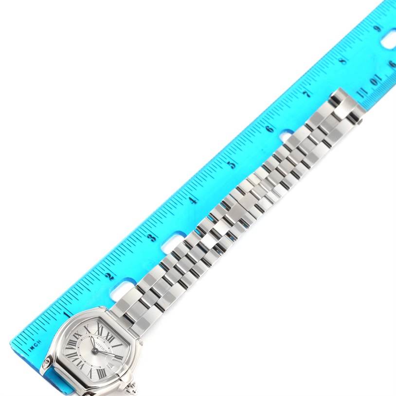 The image shows the Cartier Roadster W62016V3 Women
s Stainless Steel Silver Dial W62016V3 Women
s Stainless Steel Silver Dial watch from a top angle, highlighting its dial and full bracelet against a ruler.