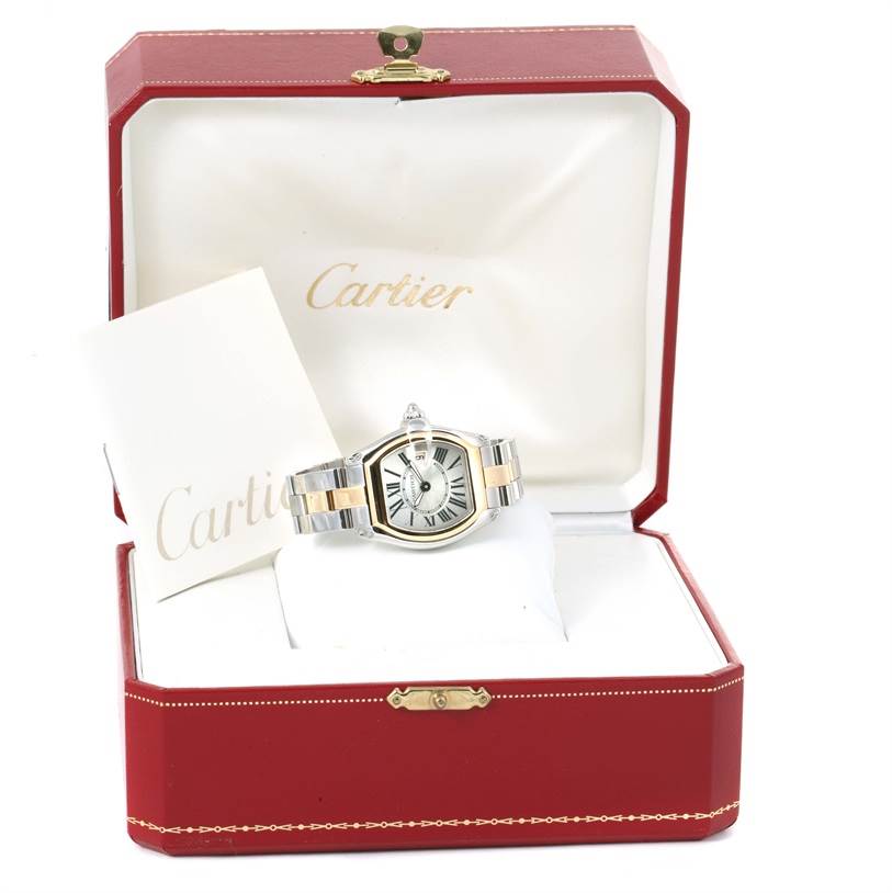 The Cartier Roadster W62026Y4 Women's Steel and Gold (two tone) Silver Dial W62026Y4 Women's Steel and Gold (two tone) Silver Dial watch is shown front-facing in its open red case, accompanied by a booklet.