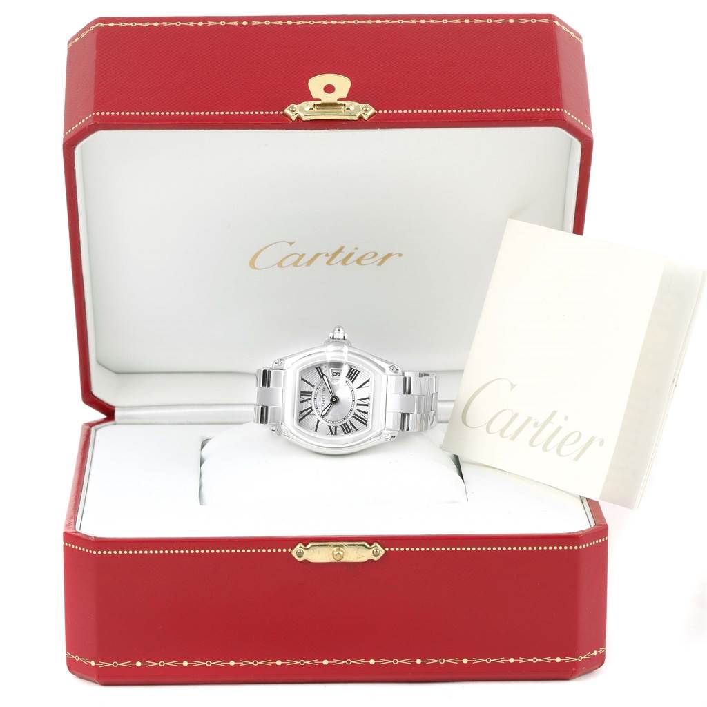 The Cartier Roadster W62016V3 Women
s Stainless Steel Silver Dial W62016V3 Women
s Stainless Steel Silver Dial watch is shown from the front with its packaging and a booklet included.