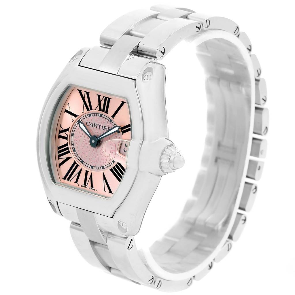 The image shows a Cartier Roadster W62043V3 Women's Stainless Steel Pink Dial W62043V3 Women's Stainless Steel Pink Dial watch from a slightly angled top view, highlighting the pink dial, Roman numerals, and metal bracelet.