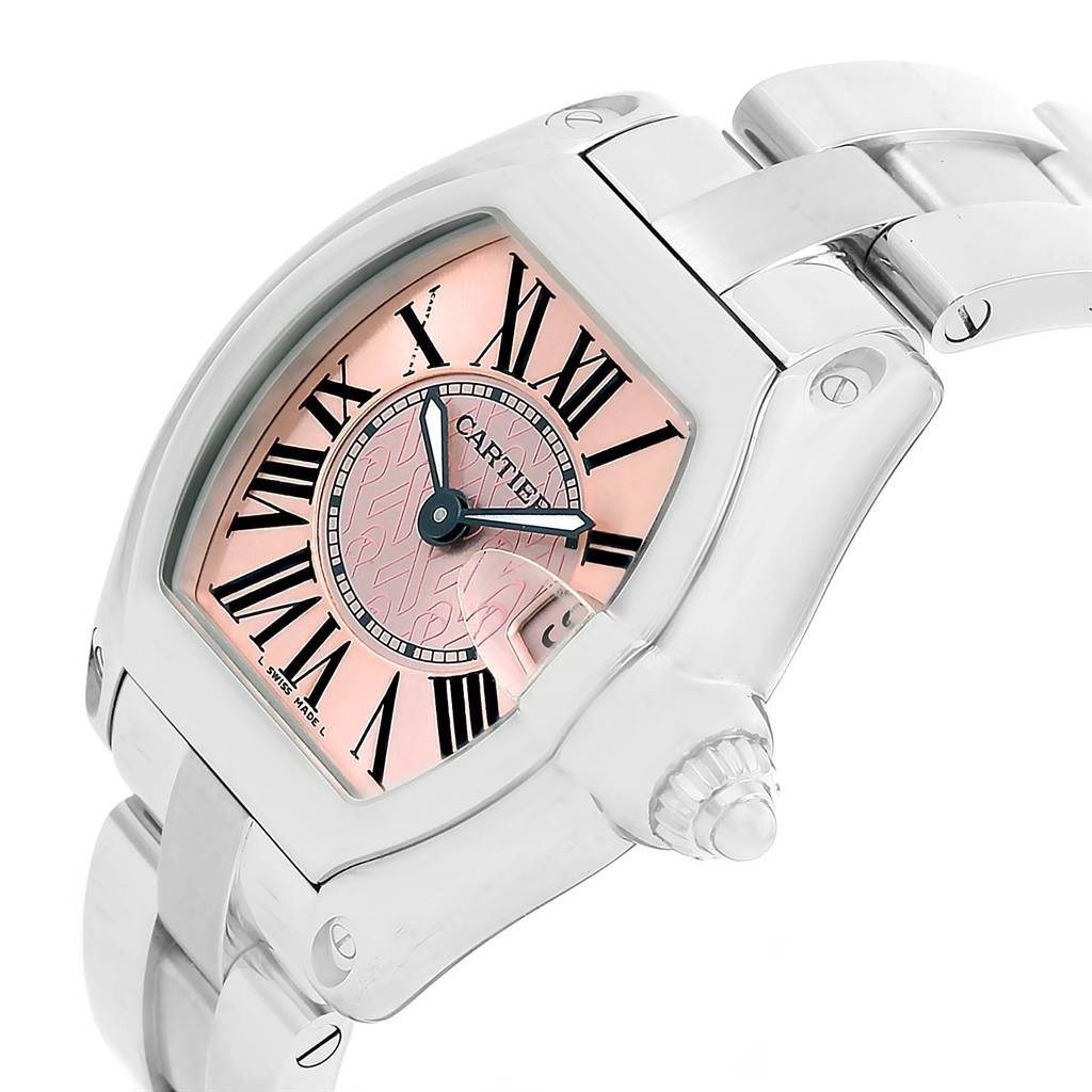 The Cartier Roadster W62043V3 Women's Stainless Steel Pink Dial W62043V3 Women's Stainless Steel Pink Dial watch is shown at an oblique angle, highlighting the pink dial, Roman numerals, and part of the bracelet.