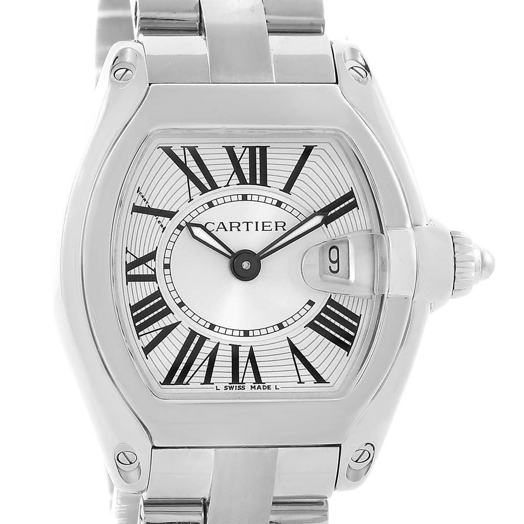 The Cartier Roadster W62016V3 Women's Stainless Steel Silver Dial W62016V3 Women's Stainless Steel Silver Dial watch is shown from a front angle, displaying the dial, hands, Roman numerals, date window, and part of the bracelet.