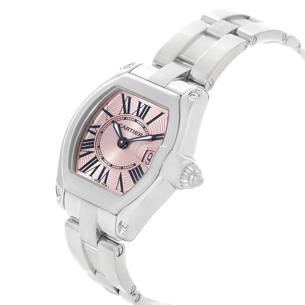 The image shows a Cartier Roadster W62017V3 Women
s Stainless Steel Pink Dial W62017V3 Women
s Stainless Steel Pink Dial watch from an angled side view, highlighting the pink dial, Roman numerals, case, and bracelet.