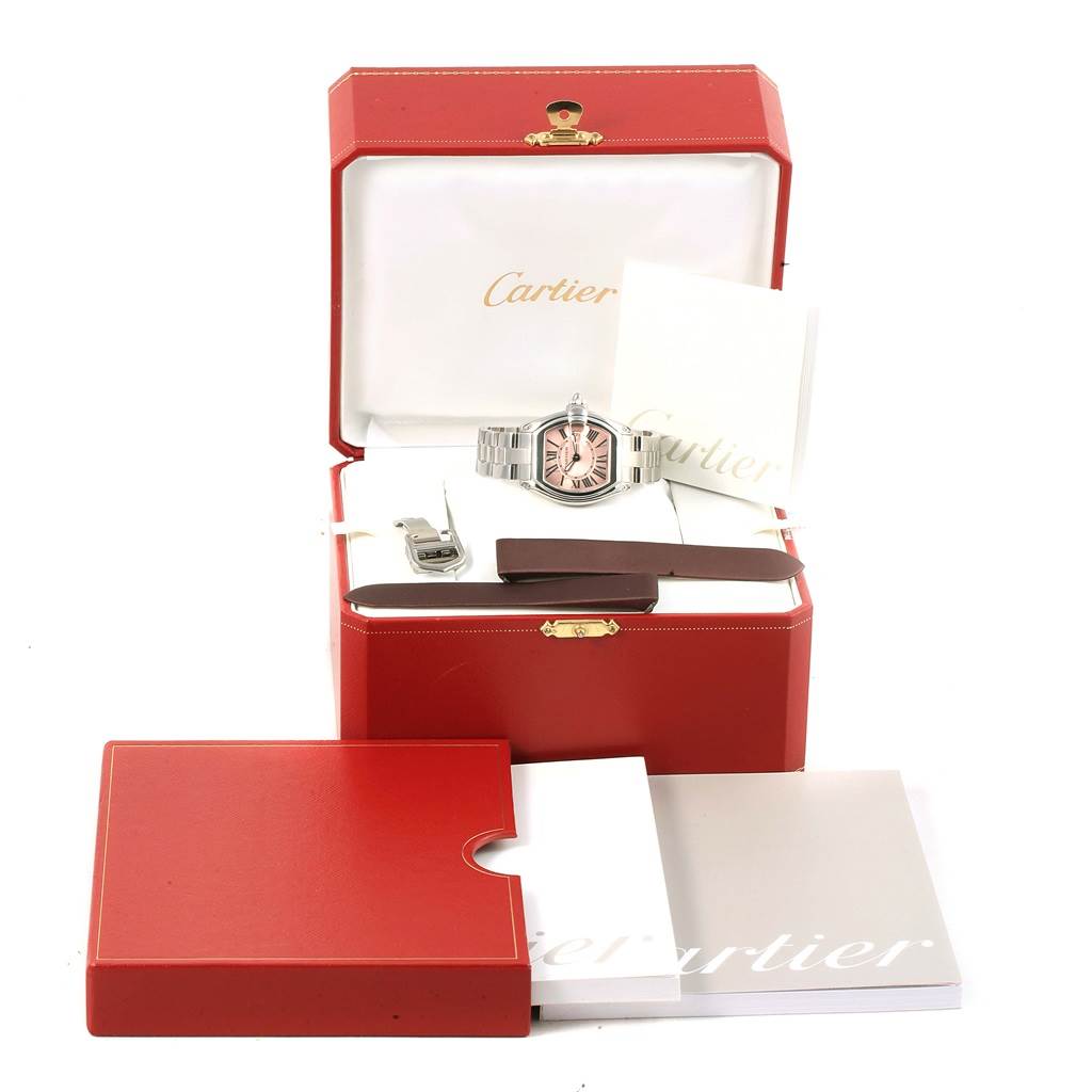 This image shows a Cartier Roadster W62017V3 Women
s Stainless Steel Pink Dial W62017V3 Women
s Stainless Steel Pink Dial watch, box, manuals, additional bracelet parts, and accessories.