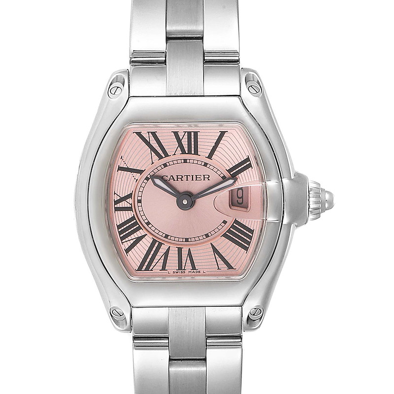 The image shows a front view of a Cartier Roadster watch, highlighting its pink dial, Roman numerals, and metal bracelet.