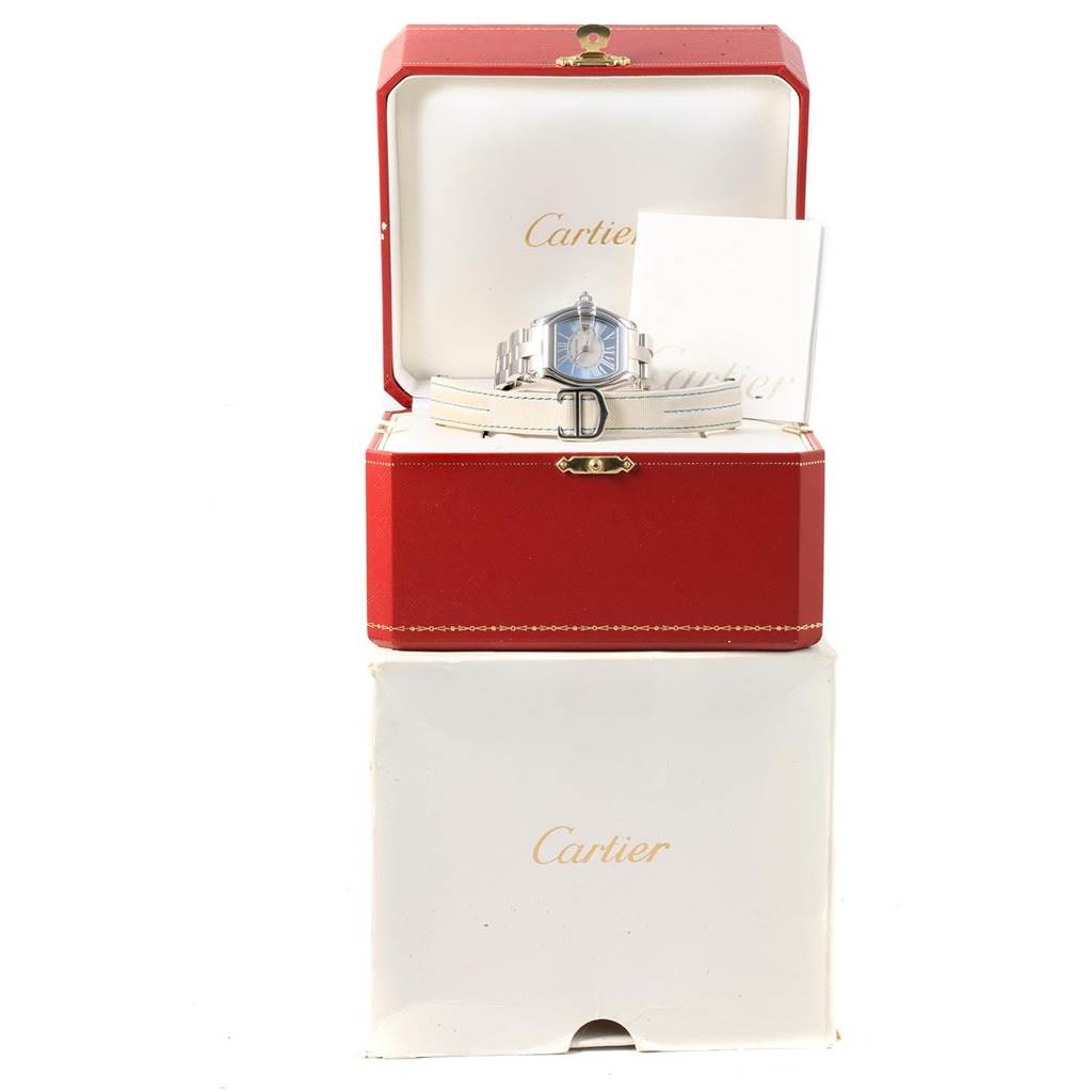 The Cartier Roadster W62053V3 Women's Stainless Steel Blue Dial W62053V3 Women's Stainless Steel Blue Dial watch is displayed front-on with its box, extra strap, and documentation.