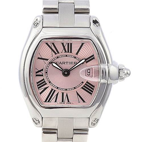 The image shows a Cartier Roadster W62017V3 Women
s Stainless Steel Pink Dial W62017V3 Women
s Stainless Steel Pink Dial watch from a front angle, displaying its pink dial, Roman numerals, date window, and stainless steel bracelet.