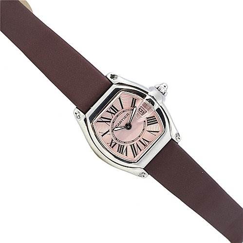 The image shows a Cartier Roadster W62017V3 Women
s Stainless Steel Pink Dial W62017V3 Women
s Stainless Steel Pink Dial watch at an angled view, highlighting its pink dial, Roman numerals, and a brown strap.