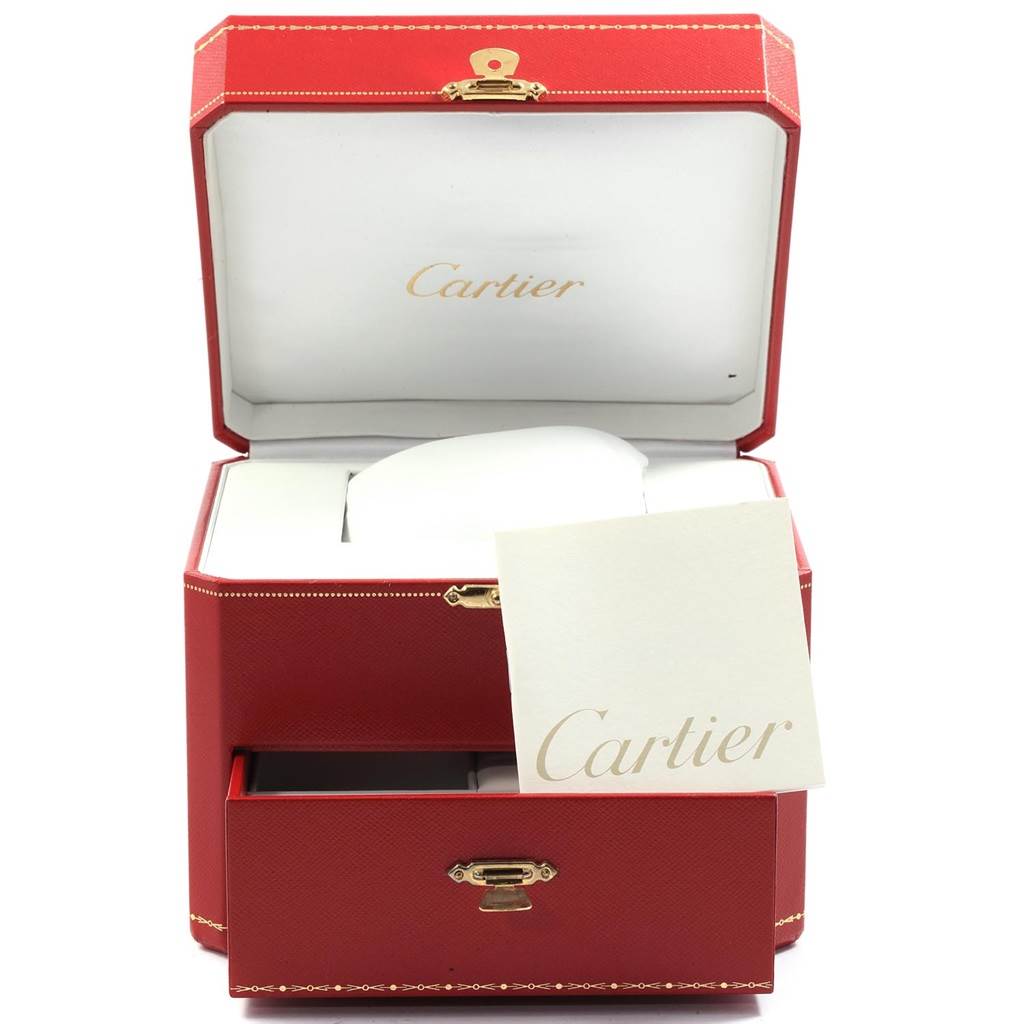 The image shows a Cartier Roadster W62018Y5 Women's Yellow Gold Silver Dial W62018Y5 Women's Yellow Gold Silver Dial watch box, including a red case with the lid open and a booklet beside it.