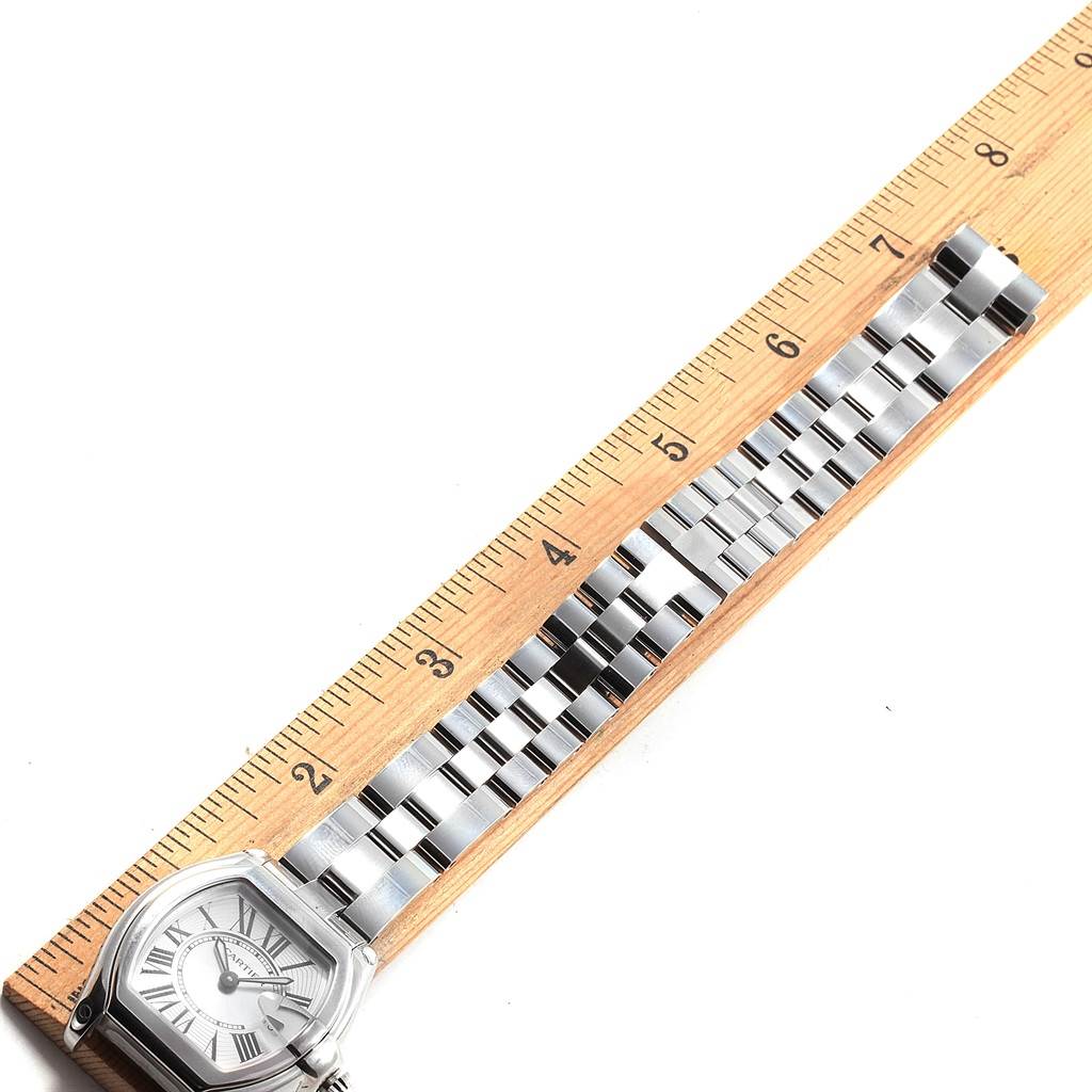 The image shows a Cartier Roadster W62016V3 Women
s Stainless Steel Silver Dial W62016V3 Women
s Stainless Steel Silver Dial watch laid flat next to a ruler for measurement.