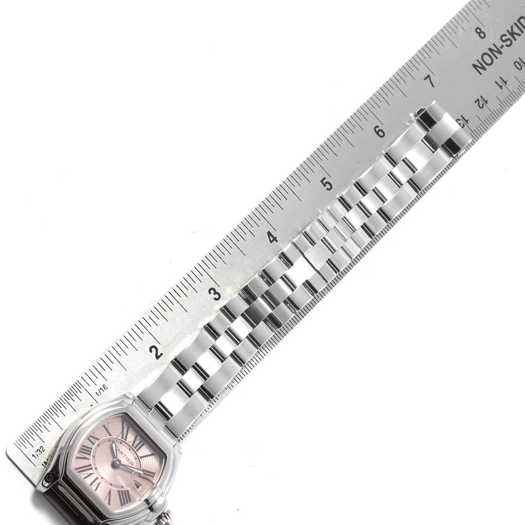 The image shows the face and part of the bracelet of a Cartier Roadster W62017V3 Women
s Stainless Steel Pink Dial W62017V3 Women
s Stainless Steel Pink Dial watch, alongside a ruler for measurement.