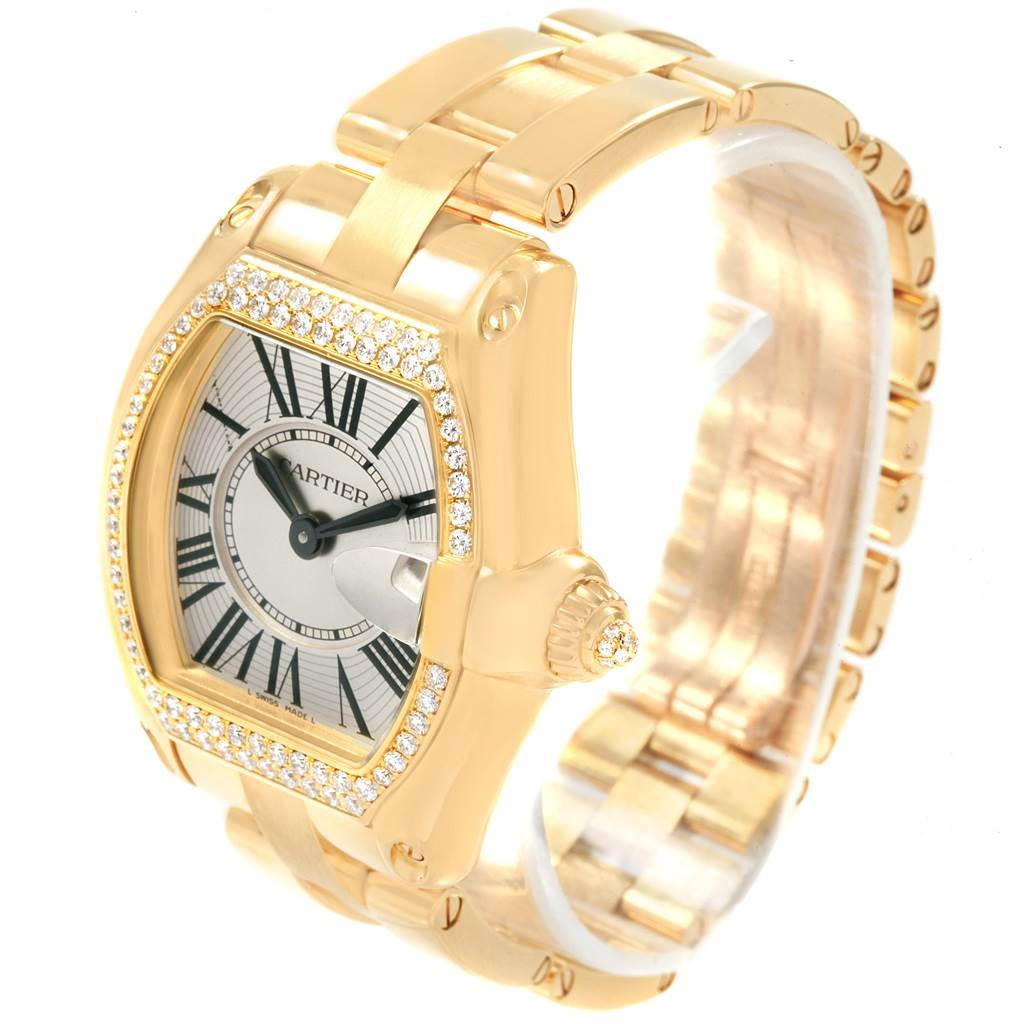 The Cartier Roadster WE5001X1 Women's Yellow Gold Silver Dial WE5001X1 Women's Yellow Gold Silver Dial watch is shown from a three-quarter angle, highlighting its gold case, diamond bezel, and bracelet.