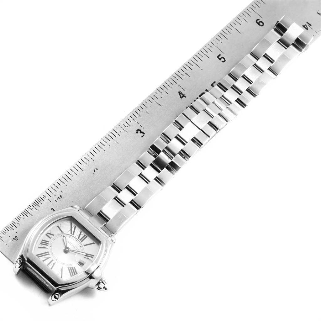 The image shows the Cartier Roadster W62016V3 Women
s Stainless Steel Silver Dial W62016V3 Women
s Stainless Steel Silver Dial watch laid flat, with the full face, bracelet, and part of a measuring ruler.