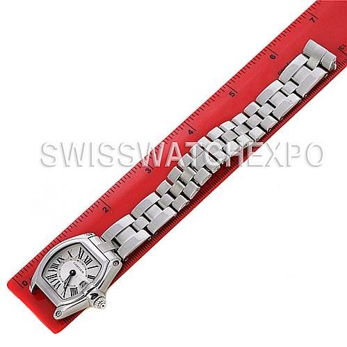 This image shows a top-down view of a Cartier Roadster W62016V3 Women
s Stainless Steel Silver Dial W62016V3 Women
s Stainless Steel Silver Dial watch with a stainless steel bracelet aligned next to a red ruler.