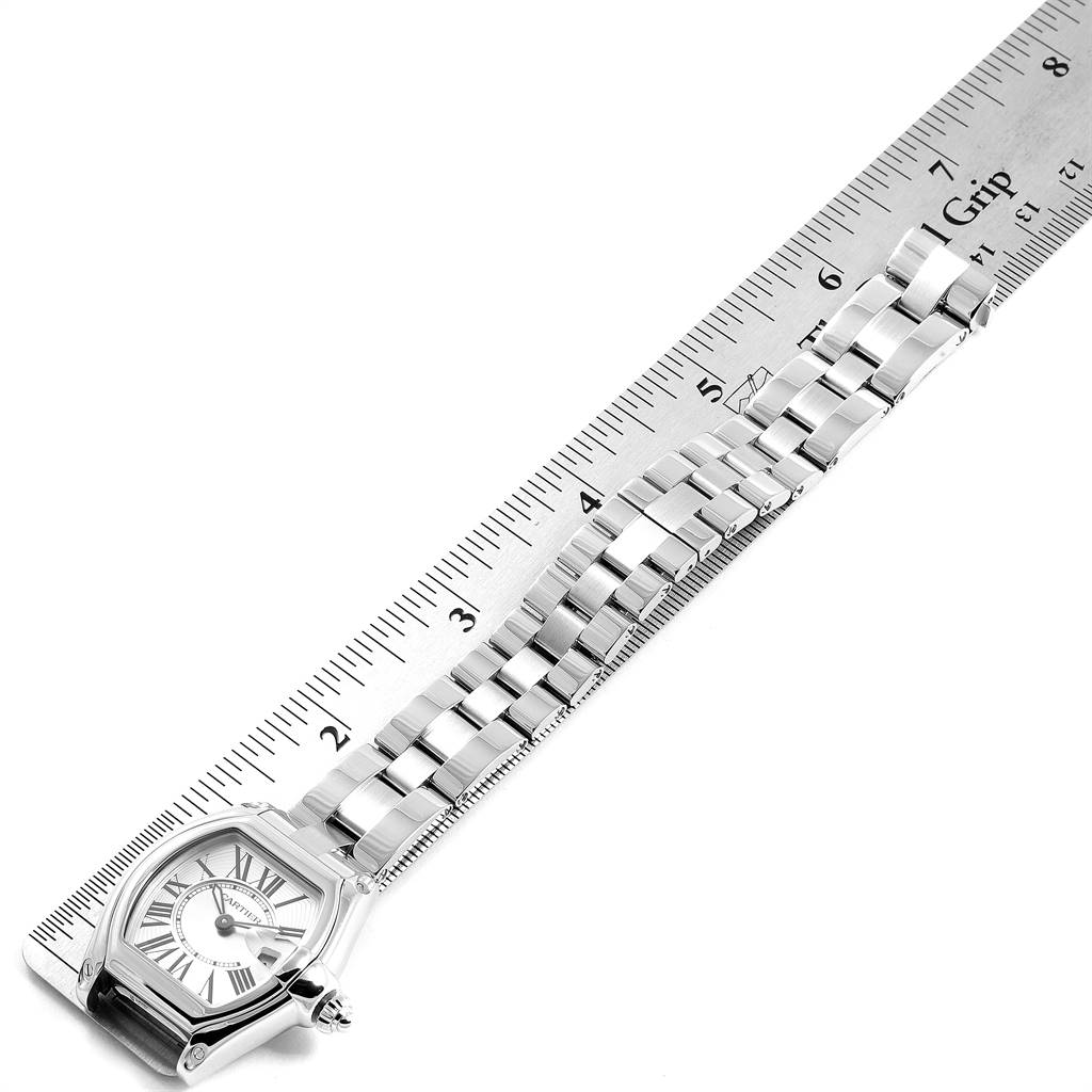 The image shows the face and metal strap of a Cartier Roadster W62016V3 Women
s Stainless Steel Silver Dial W62016V3 Women
s Stainless Steel Silver Dial watch, positioned alongside a ruler for scale.