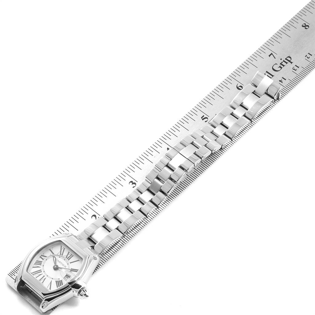 The Cartier Roadster W62016V3 Women's Stainless Steel Silver Dial W62016V3 Women's Stainless Steel Silver Dial watch is shown from a top-down angle, displaying the face and metal bracelet alongside a ruler for scale.