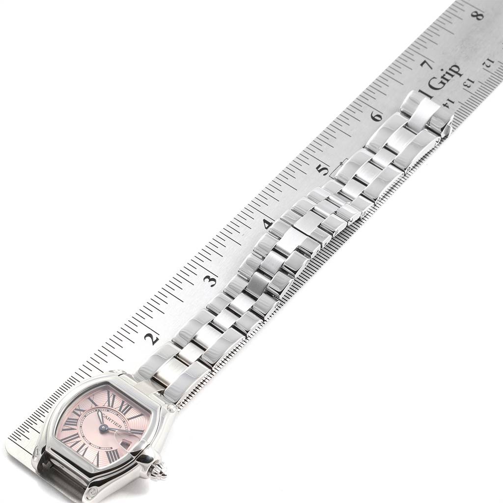 The image shows a Cartier Roadster W62017V3 Women's Stainless Steel Pink Dial W62017V3 Women's Stainless Steel Pink Dial watch lying flat with a ruler measuring its metal bracelet.